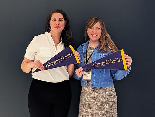 photo of two women holding pennants